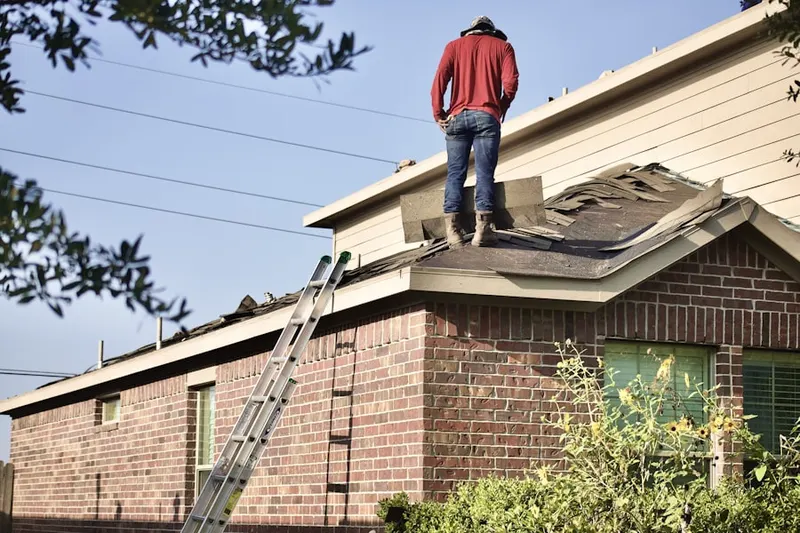 Professional roofer working on a residential roof in Leopard Farms